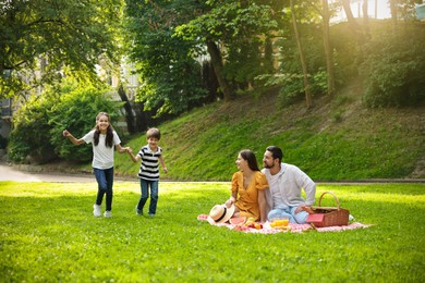 Photo of Happy children playing during family picnic outdoors