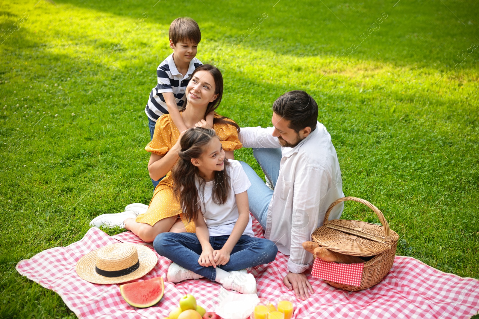 Photo of Happy family having picnic together in park