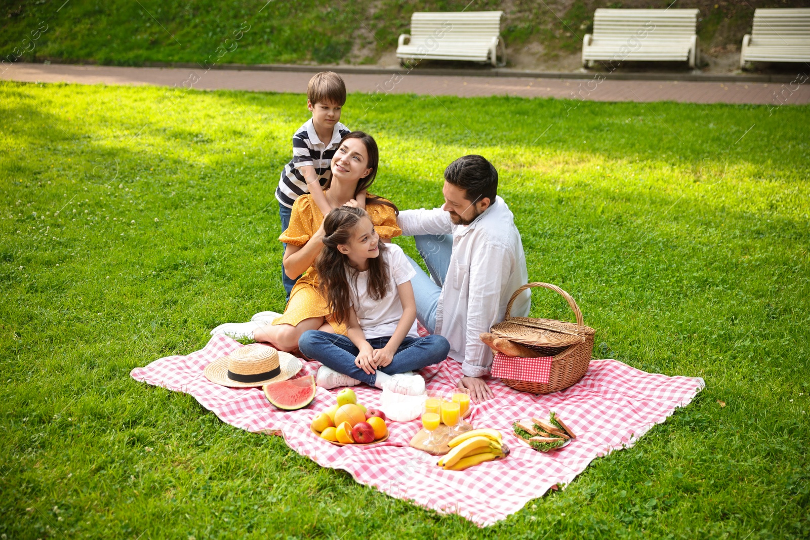 Photo of Happy family having picnic together in park