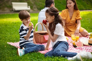 Photo of Lovely family having picnic together in park
