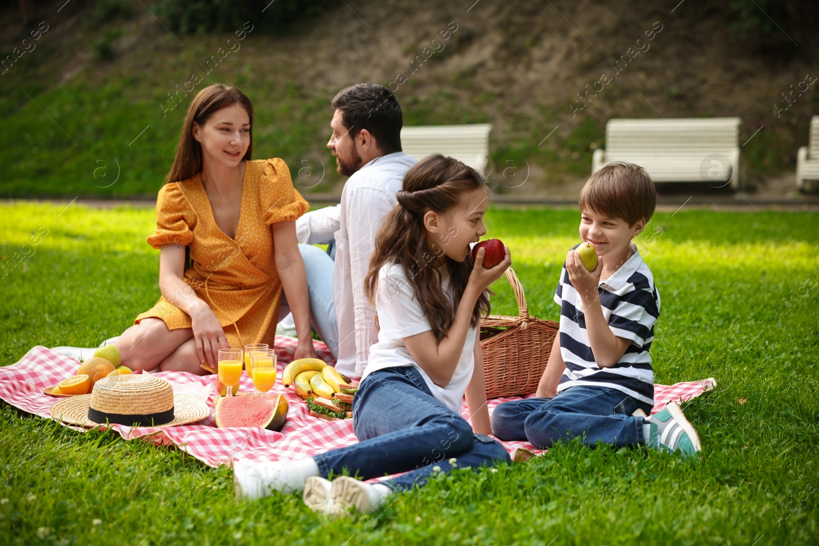 Photo of Lovely family having picnic together in park