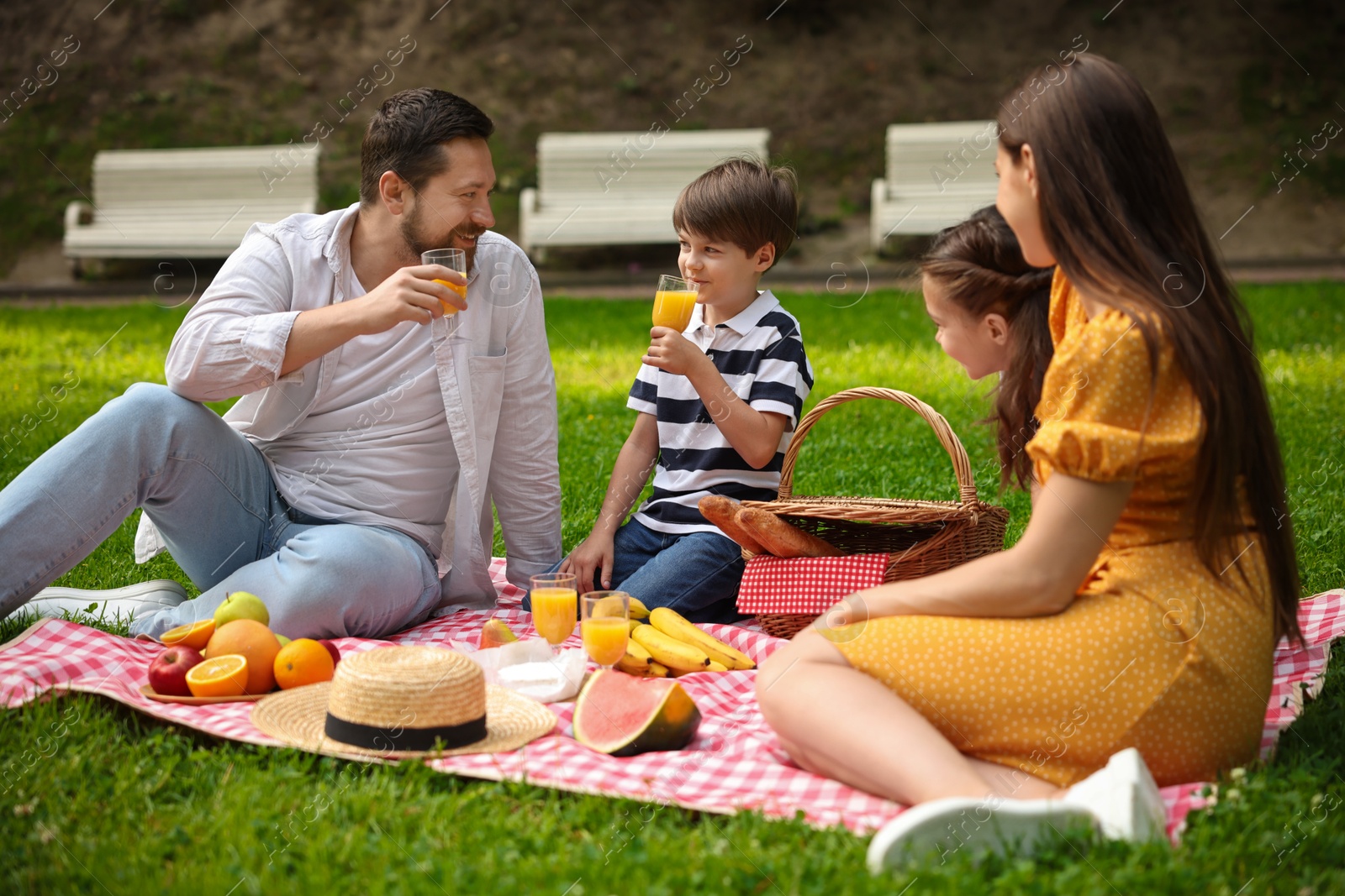 Photo of Happy family having picnic together in park