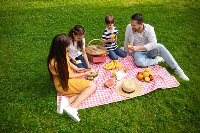 Photo of Lovely family having picnic together in park