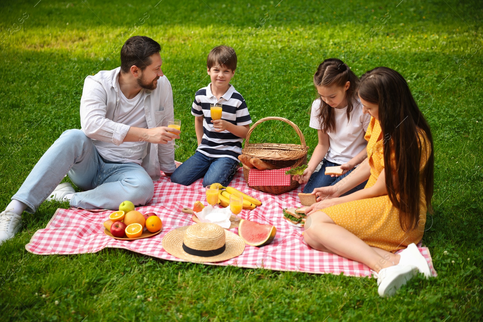 Photo of Lovely family having picnic together in park