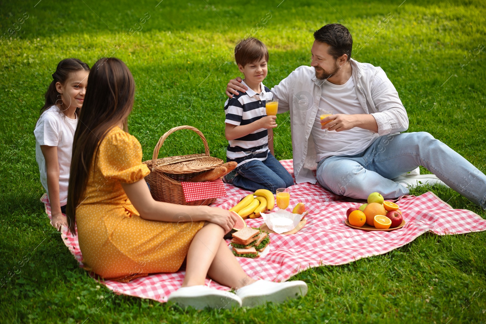 Photo of Lovely family having picnic together in park