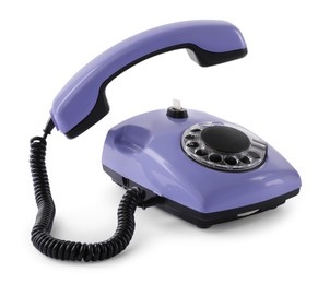 Photo of One violet telephone with handset isolated on white