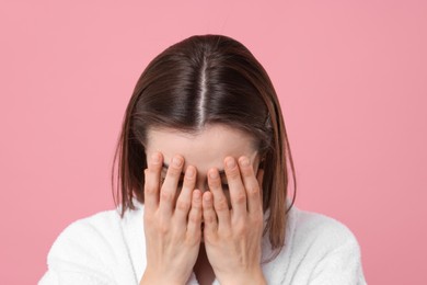 Photo of Woman suffering from hair loss problem on pink background