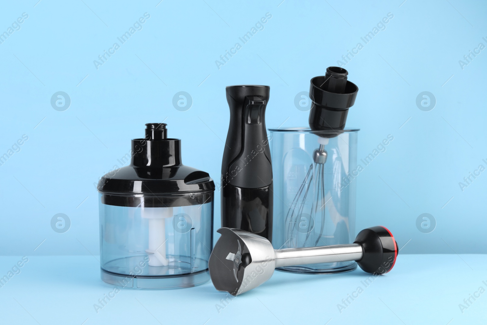 Photo of Hand blender kit on light blue background