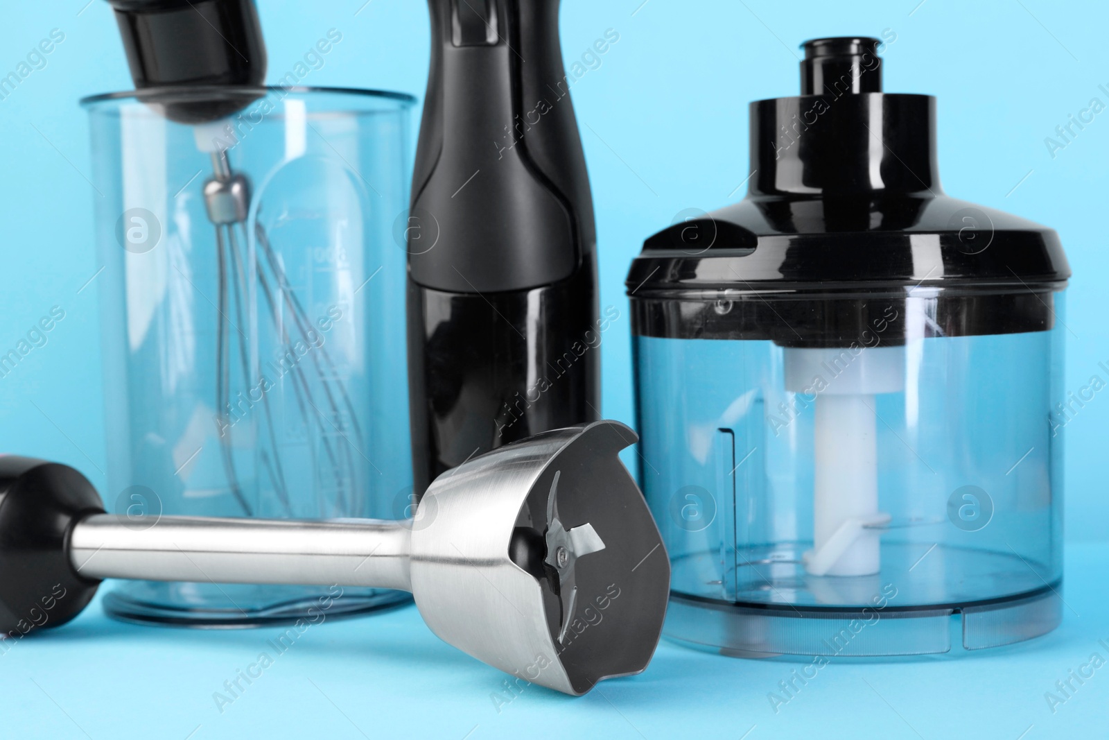 Photo of Hand blender kit on light blue background, closeup