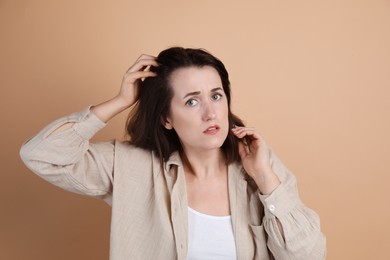 Photo of Woman with hair loss problem on beige background