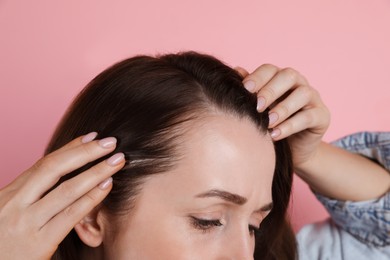 Photo of Woman with hair loss problem on pink background, closeup