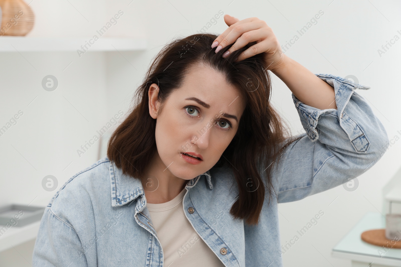 Photo of Woman with hair loss problem at home