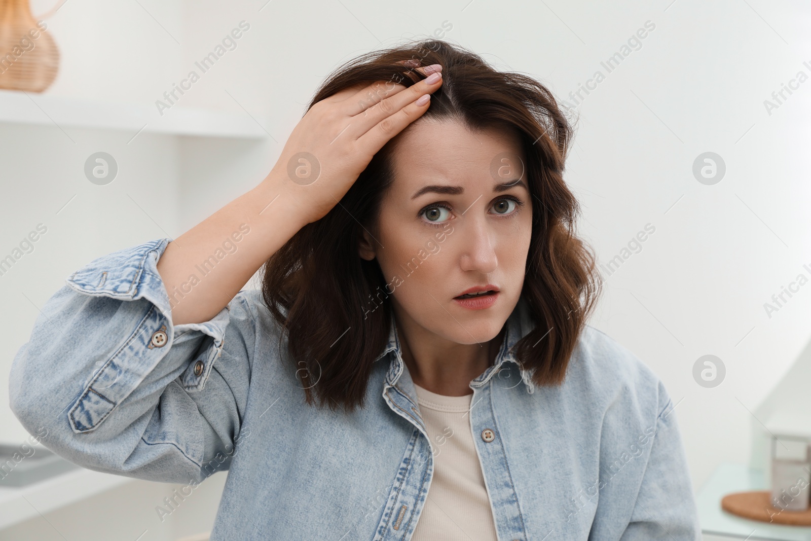 Photo of Woman with hair loss problem at home