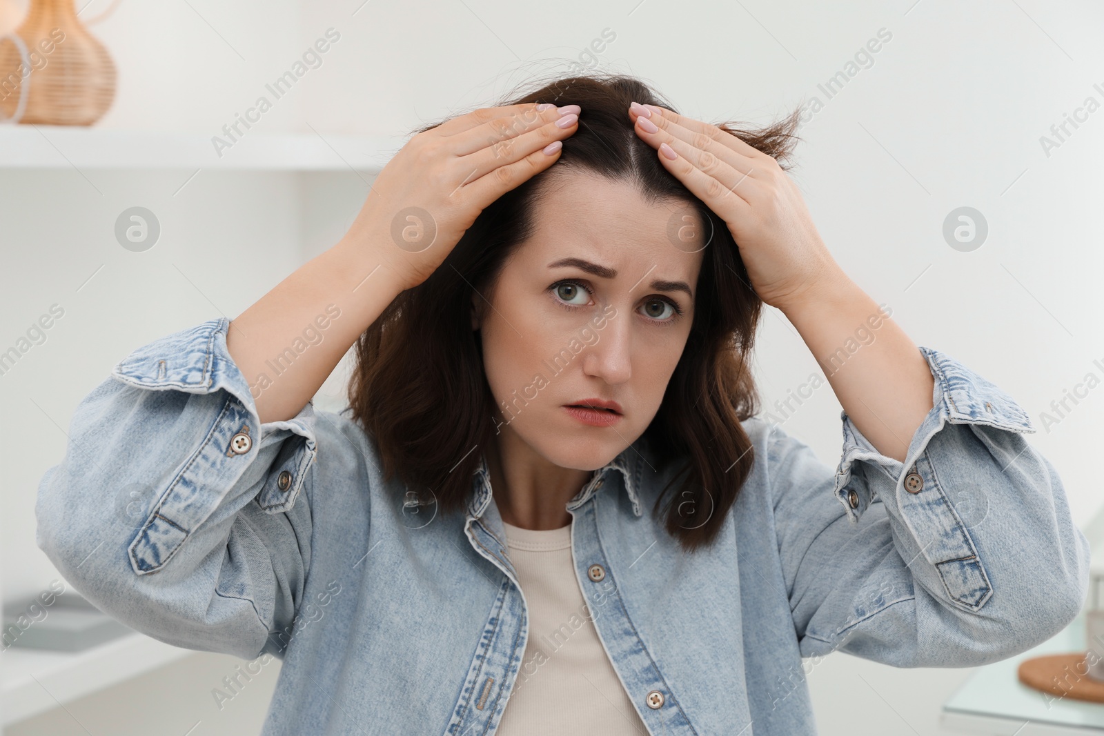 Photo of Woman with hair loss problem at home