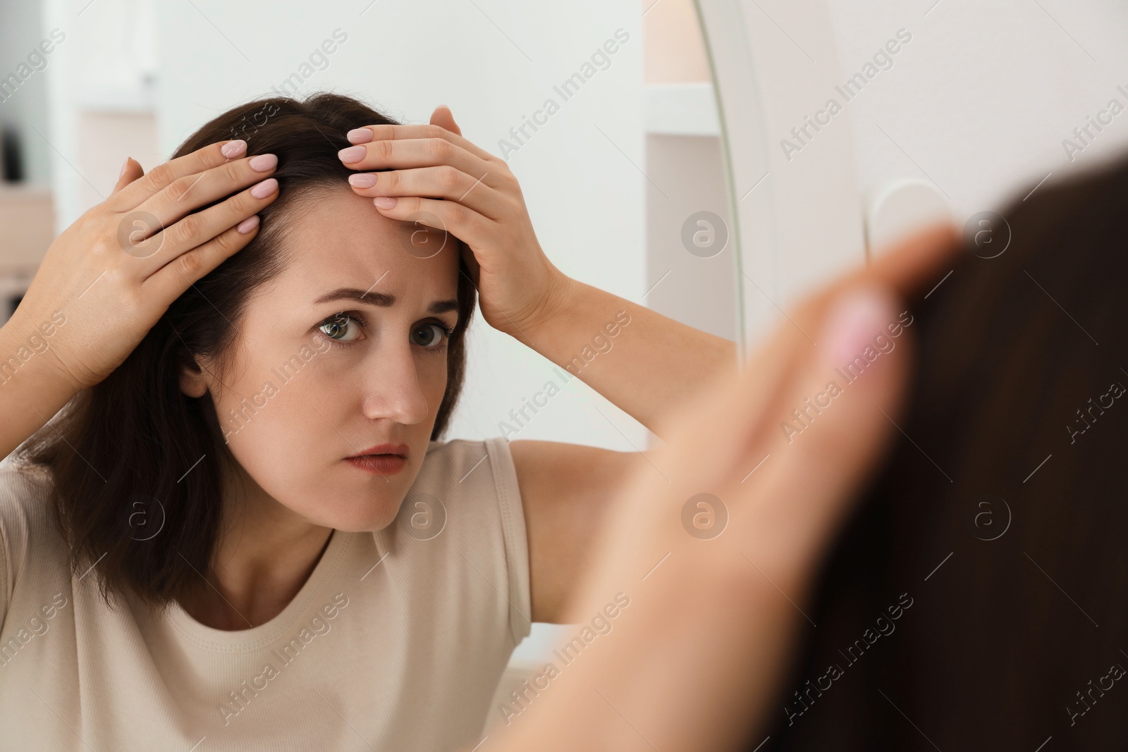 Photo of Woman with hair loss problem at home