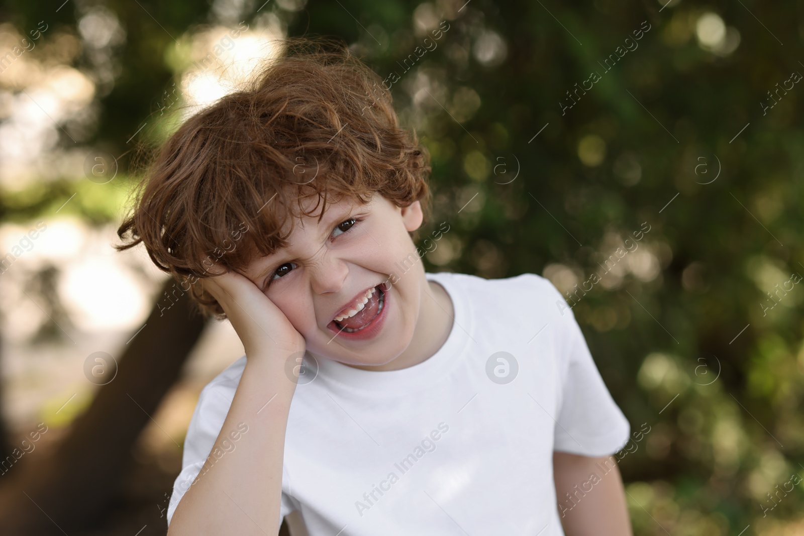 Photo of Portrait of emotional boy outdoors. Cute child