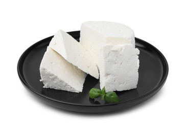 Photo of Fresh ricotta (cream cheese) and basil isolated on white