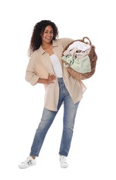 Happy woman with basket full of laundry on white background