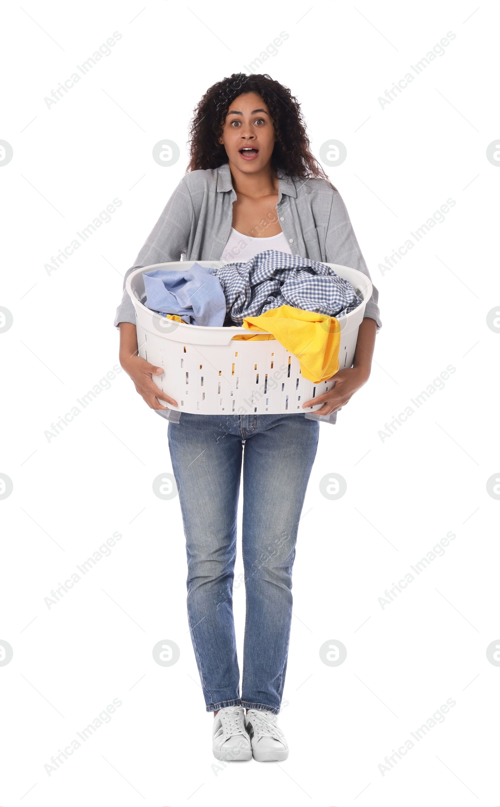 Photo of Shocked woman with basket full of laundry on white background