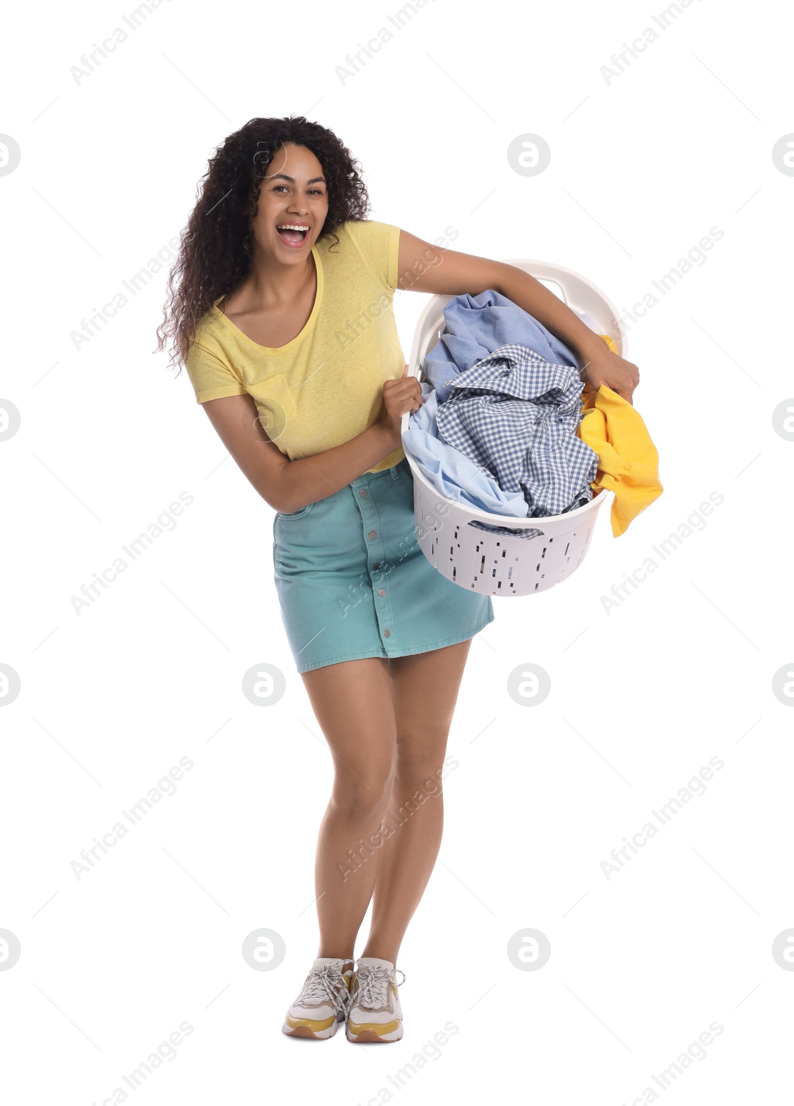 Photo of Happy woman with basket full of laundry on white background