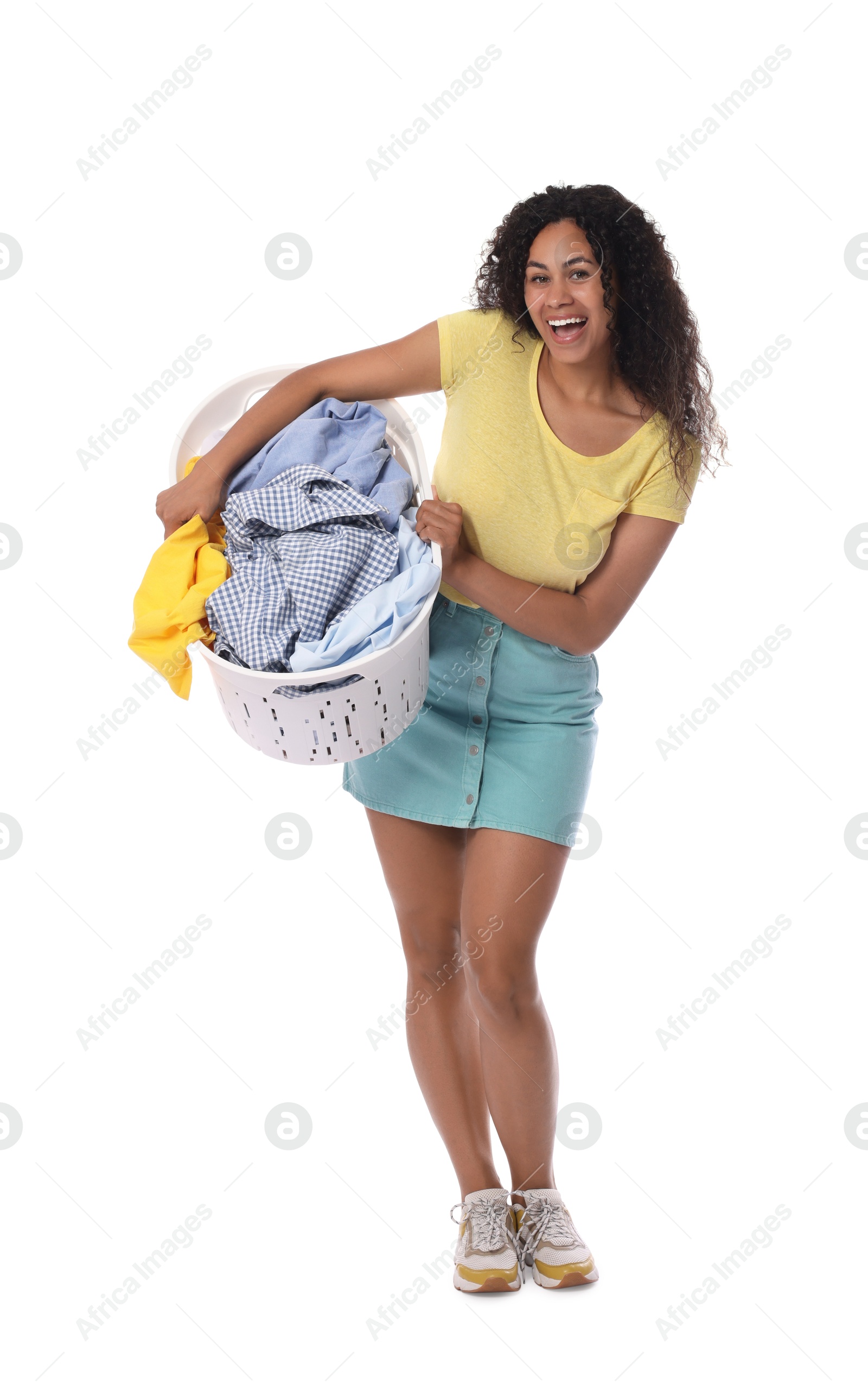 Photo of Happy woman with basket full of laundry on white background