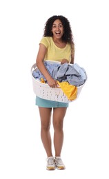 Happy woman with basket full of laundry on white background