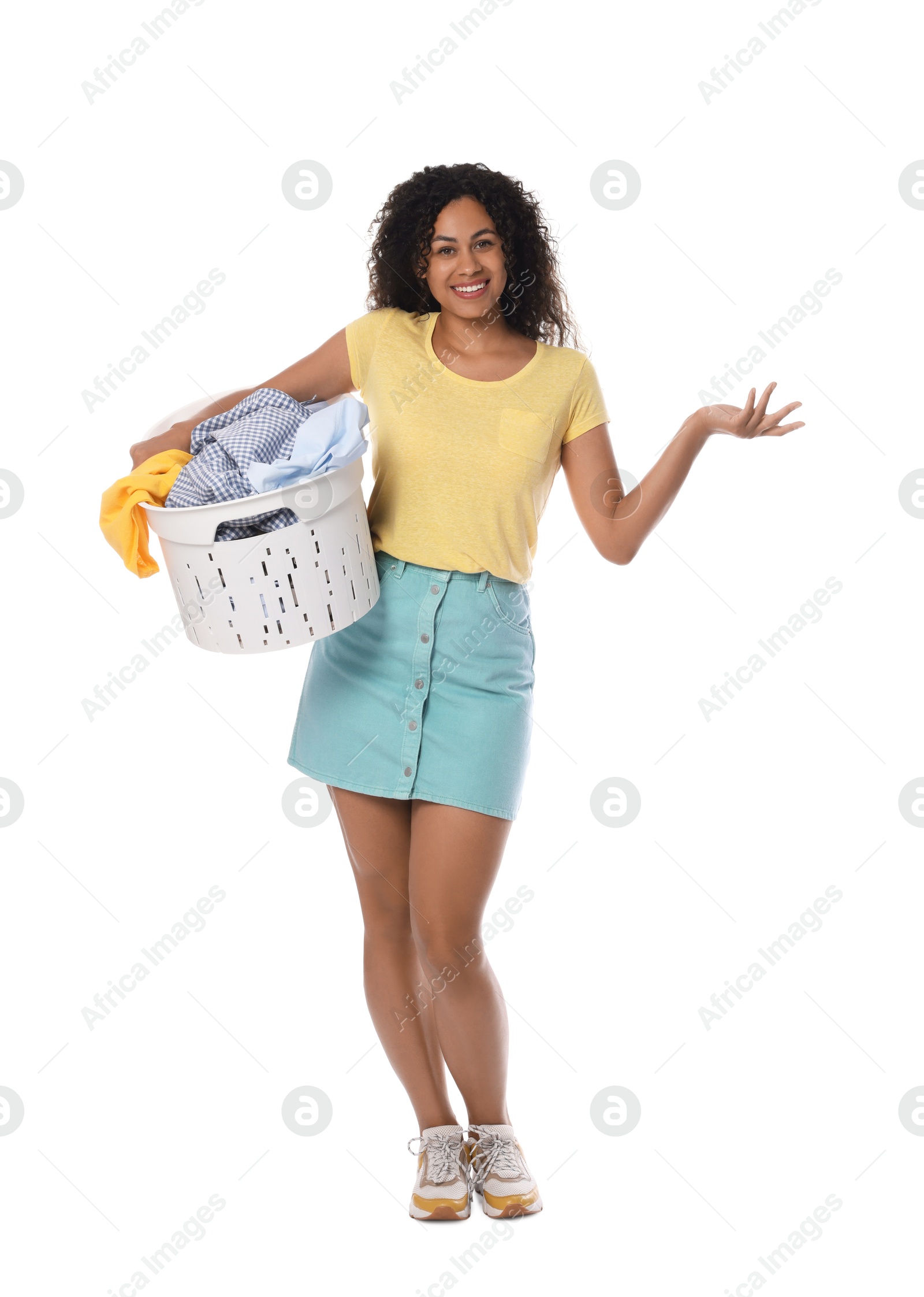 Photo of Happy woman with basket full of laundry on white background