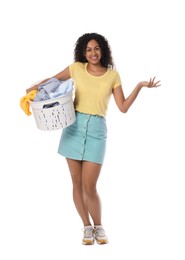 Photo of Happy woman with basket full of laundry on white background