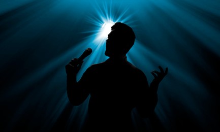 Image of Silhouette of singer on stage in spotlight. Banner design