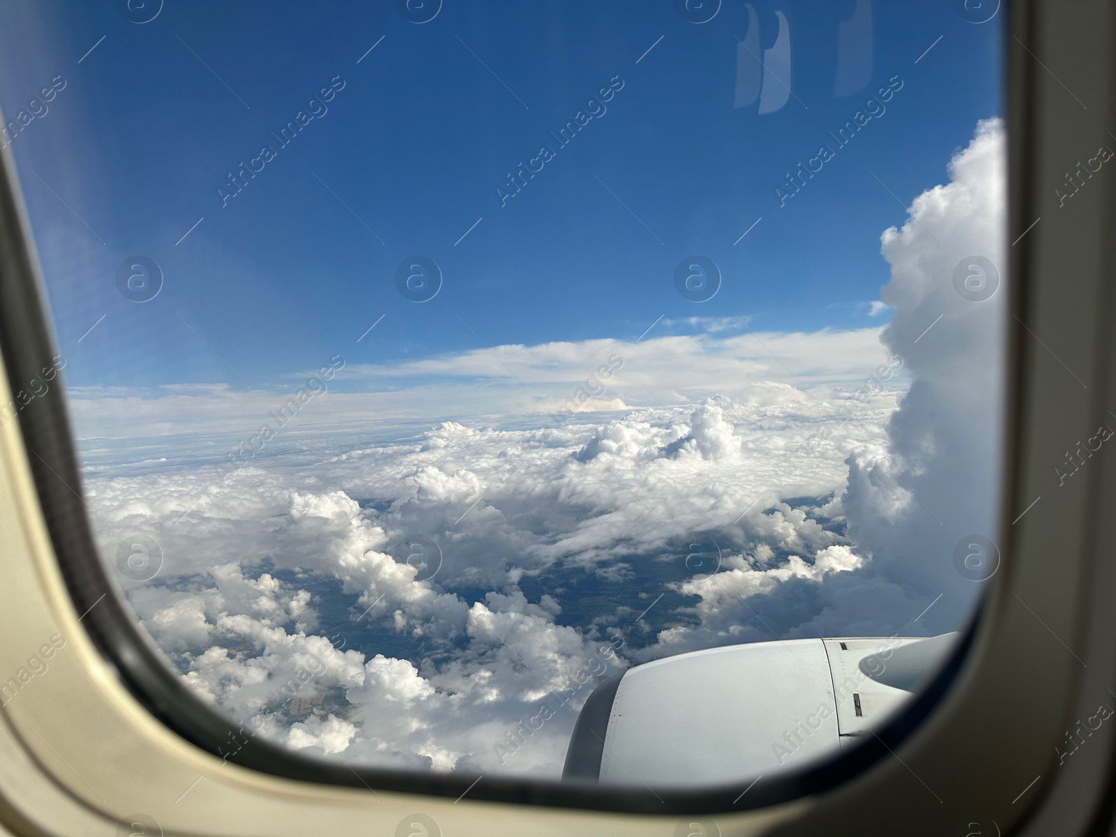 Photo of Beautiful blue sky with fluffy clouds, view from plane window