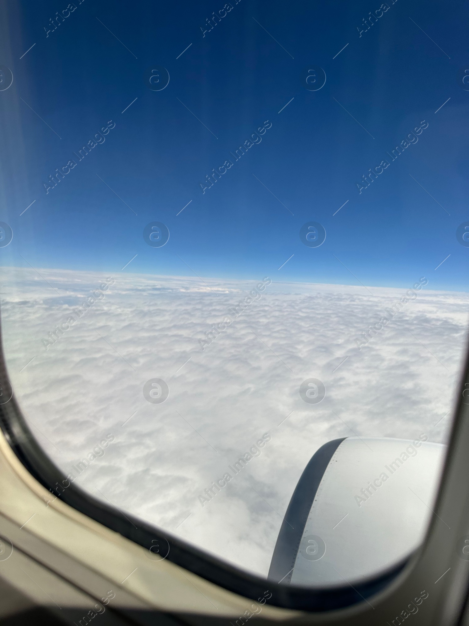 Photo of Beautiful blue sky with fluffy clouds, view from plane window