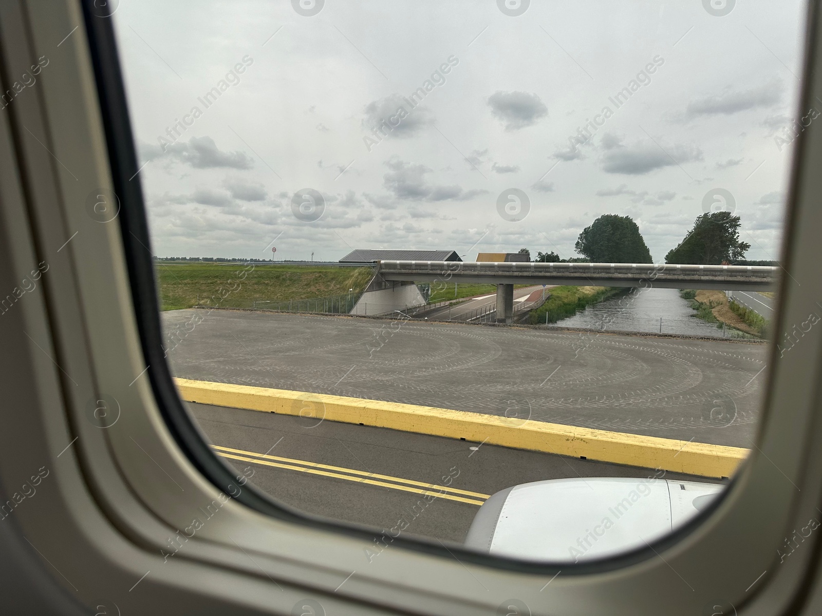 Photo of View on runway and surroundings through plane window