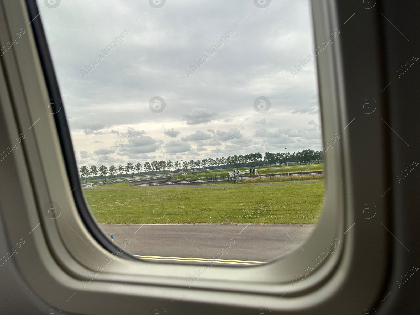 Photo of View on runway and surroundings through plane window