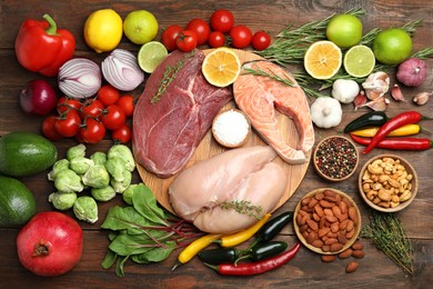 Photo of Flat lay composition with fresh meat and other products for balanced diet on wooden table