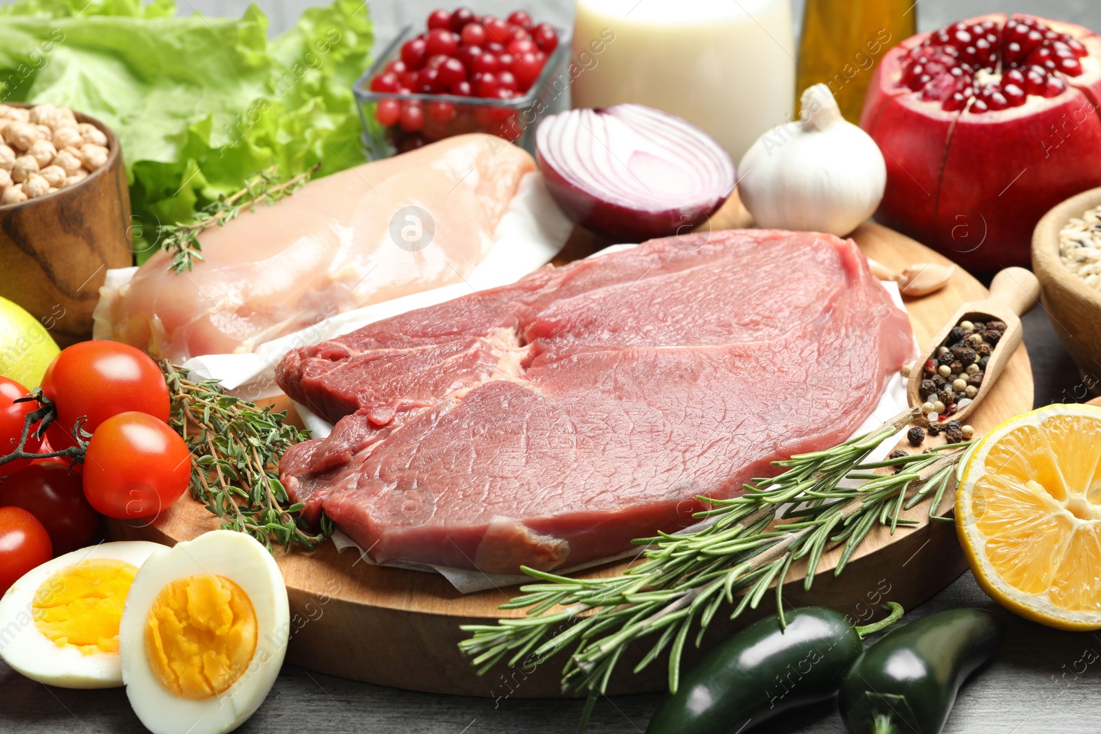 Photo of Fresh meat and other products for balanced diet on table