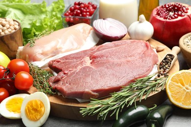 Photo of Fresh meat and other products for balanced diet on table