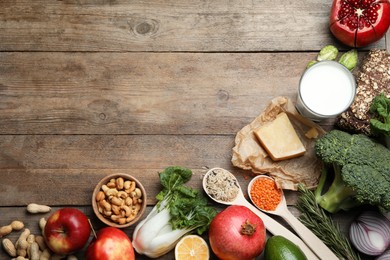 Flat lay composition with different products on wooden table, space for text. Balanced diet