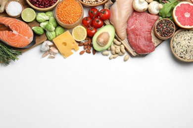 Photo of Flat lay composition with fresh meat and other products on white background, space for text. Balanced diet