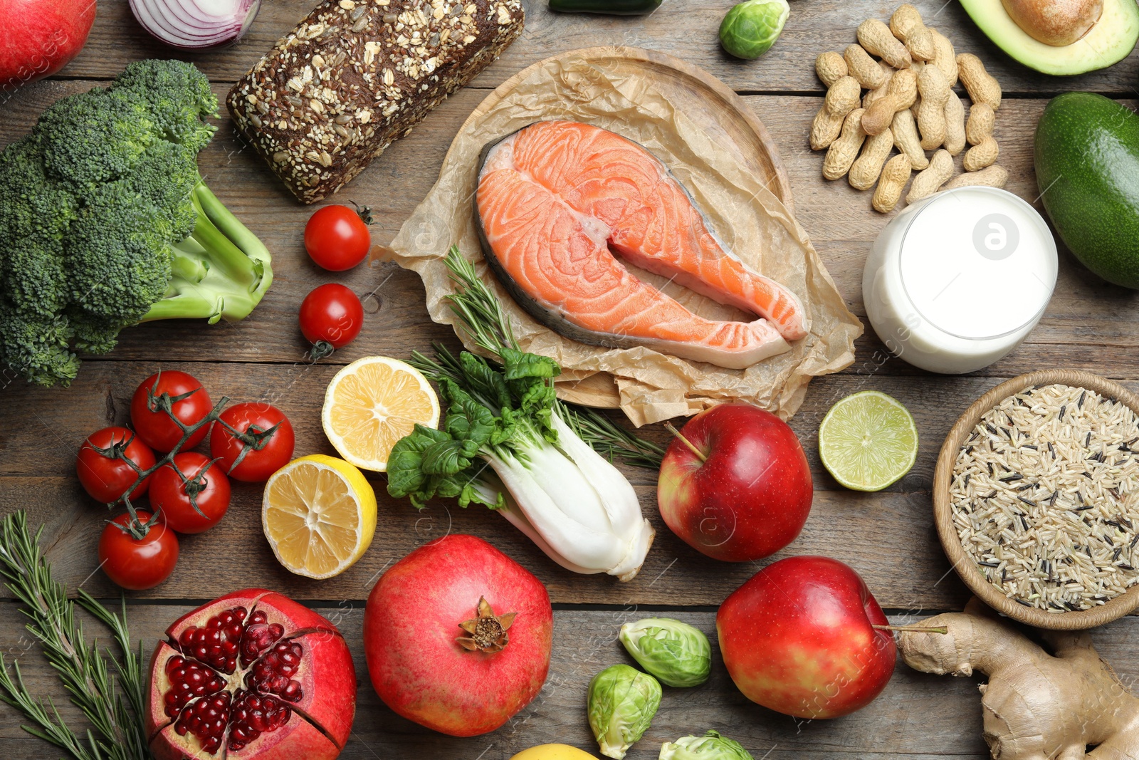 Photo of Flat lay composition with fresh fish and other products for balanced diet on wooden table