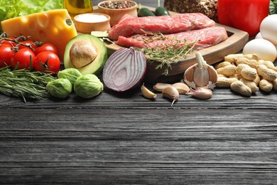 Photo of Fresh meat and other products on wooden table, space for text. Balanced diet