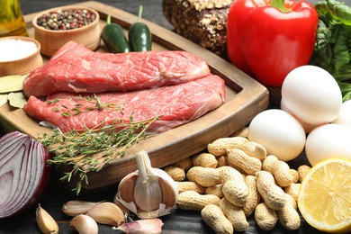 Photo of Fresh meat and other products for balanced diet on table