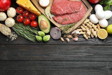 Photo of Flat lay composition with fresh meat and other products on wooden table, space for text. Balanced diet