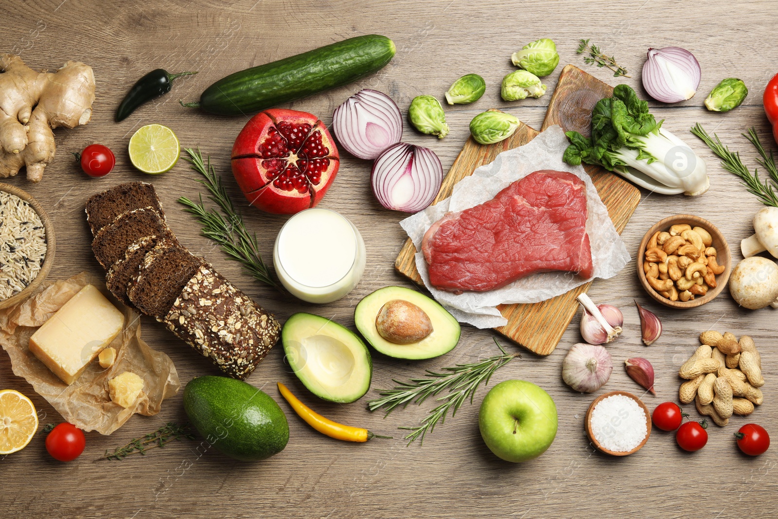 Photo of Flat lay composition with fresh meat and other products for balanced diet on wooden table