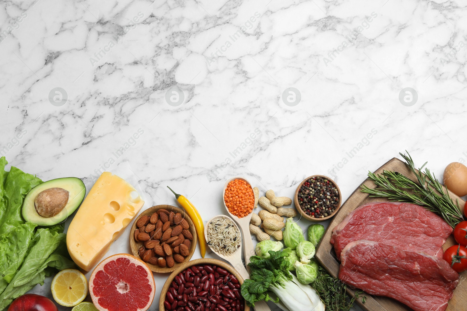 Photo of Flat lay composition with fresh meat and other products on white marble table, space for text. Balanced diet