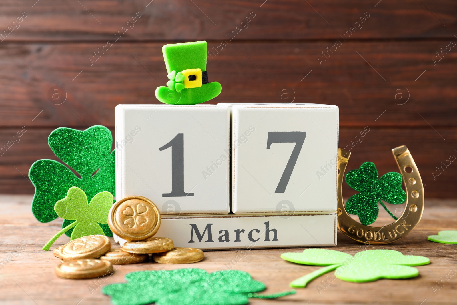 Photo of Composition with block calendar on wooden table. St. Patrick's Day celebration