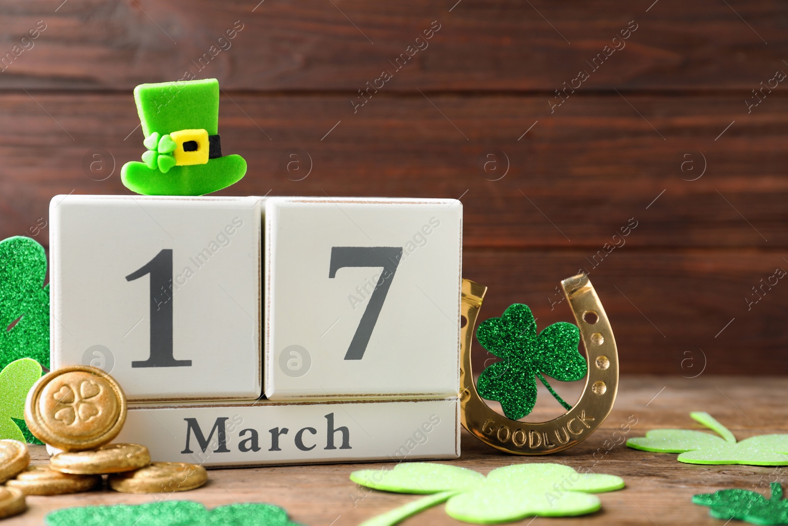 Photo of Composition with block calendar on wooden table. St. Patrick's Day celebration