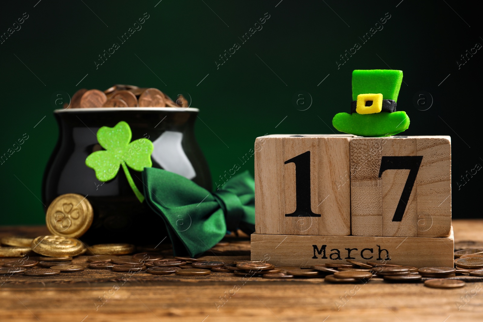 Photo of Composition with block calendar on wooden table. St. Patrick's Day celebration