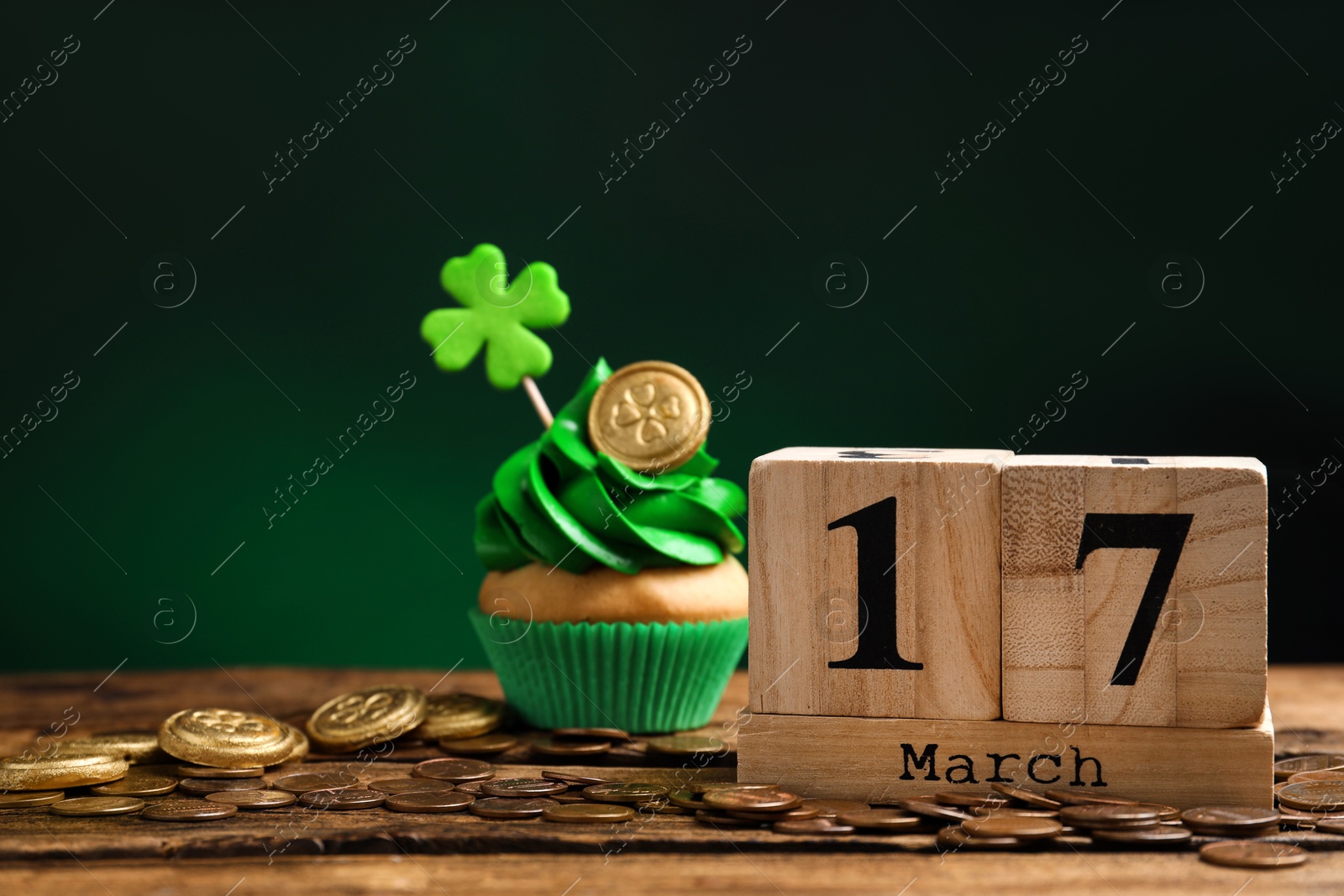 Photo of Composition with block calendar on wooden table. St. Patrick's Day celebration