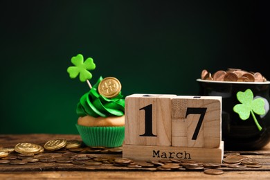 Photo of Composition with block calendar on wooden table. St. Patrick's Day celebration