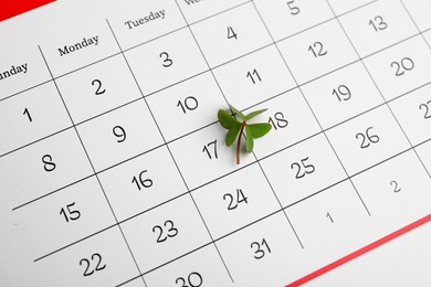 Photo of 17th March marked with fresh clover on calendar. St. Patrick's Day celebration